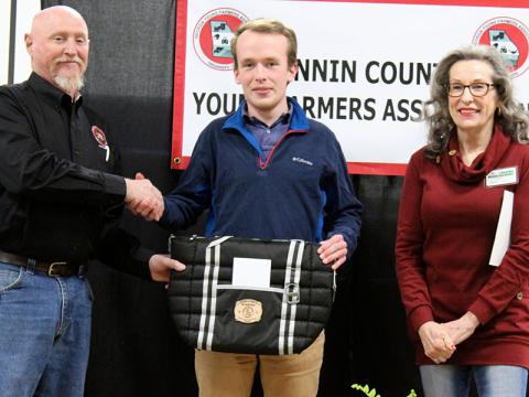 Nick Wollschlager, middle, was presented with the Beginning Agriculture Producer for 2021 award sponsored by The North Georgia Master Gardeners at the Fannin County Young Farmers Association (FCYFA) Awards Banquet Friday, February 4. He is shown with FCYFA President Kenny Queen and North Georgia Master Gardener Marie Traylor.