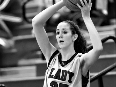 Megan looking for an open player during her days with the Lady Rebels.