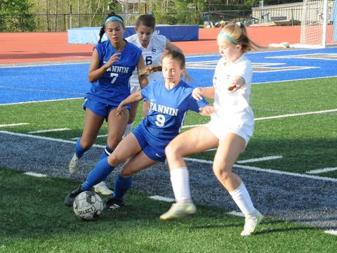 Fannin County’s Karmah Eaton (9) moves the ball against a Pace defender in the Lady Rebels state playoff match April 25. Taylor Poland (7), who had four steals in the match, follows the play.