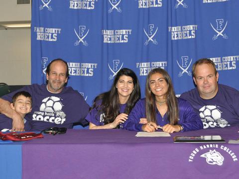 Taylor Poland smiles after signing her letter of intent to play soccer at Young Harris College. Shown are, from left, Levi, Carl and Rebecca Weinzierl, Poland and Ronnie Poland.