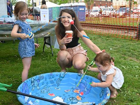 Madeleine Coddou, left, and sister, Georgia, learned about fishing and the importance of keeping our rivers trash free at the Faith Presbyterian Church, of Blue Ridge, booth during the 2022 Blue Ridge Trout and Outdoor Adventures Festival Saturday, April 30. They are shown with their mother, Jennifer. 