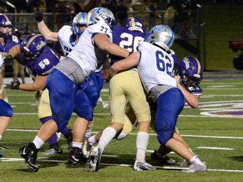 Fannin County defensive linemen Logan Long (77) and Case Holloway (62) find the ball and wrap up the Union County ball carrier in the game against Union County Friday, August 19. 
