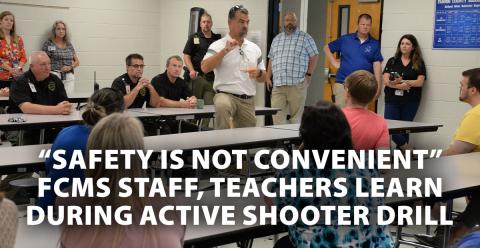 Fannin County Sheriff Dane Kirby, seated, right, and school resource officers and deputy sheriffs  Anthony Walden, seated, and Jim Burrell, listen as Fannin County School System Associate Superintendent Darren Danner talks to Fannin County Middle School staff following the active shooter drill at the school. Kirby told the staff that, while there is no way to be prepared for every situation, “you’re training will kick in.”