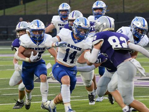 Carson Callihan, left, carries the ball up the field for the Rebels while Cooper Born (14), right, clears a path for him during the game against Gilmer County Friday, August 26. 