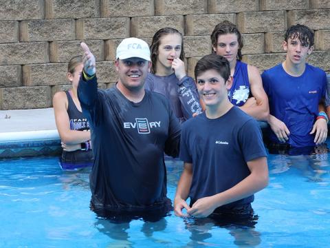 Matt Queen, left, North Central Georgia director for the Fellowship of Christian Athletes, explains the act of baptism before baptizing a smiling Vince Foster Tuesday, September 6. 