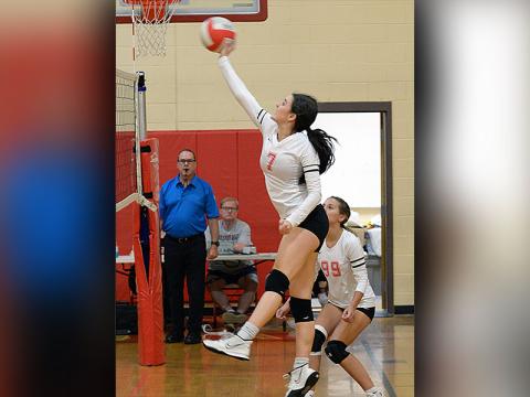 Sarah Collis (7) jumps up to hit the ball while Taylee Hall (99) plays in coverage for the Lady Cougars volleyball team Tuesday, September 6, in their match against Lookout Valley.
