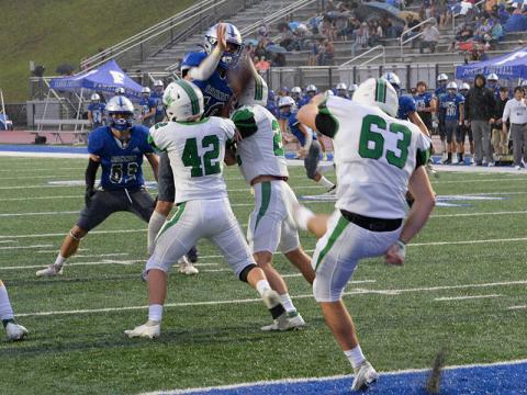 Braden Taylor (10) jumps fully extended in an effort to block a punt by Pickens County while Nate Maloof (63) stays in coverage. 