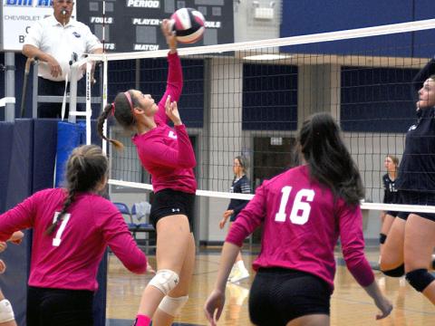 Lexi Gravely makes a return in a Lady Rebels Pink Out match as Maggie Ledford (7)and Rylee King (16) get ready in case of a return.