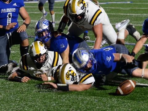 Bryan Stiles (66) and Jeremy Tammen (71) tackle two North Murray Mountaineers to force a fumble and Brayden Taylor (10) eyes the loose ball and quickly recovers it in last week’s record breaking win for the Fannin Rebels.