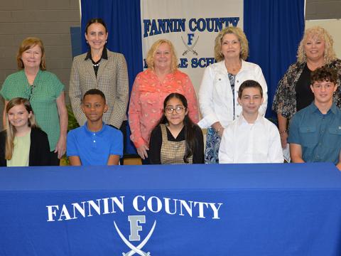 This year’s class of REACH scholars and their mentors are shown at the conclusion of last week’s signing ceremony. Shown, from left, are Sarah Brawley, Jamari Patterson, Lesly Alvarado, Ronald Kendall, and Elijah Queen, and, back, FCMS Counselor Shandra English filling in for Sheree Ralston, Summer Leifer, Rhonda Daves, Melissa King and Cindy Hicks.