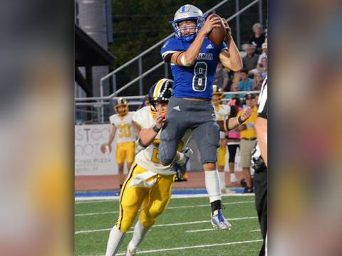 The Region 7AA’s Athlete of the Year, Corbin Davenport, goes high in the air to catch a pass in action for the Fannin County Rebels this season.