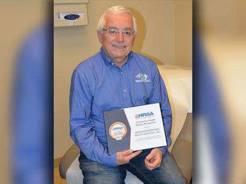 Steven Miracle, chief executive officer of Georgia Mountains Health, displays the facility received as a Quality Leader from the U.S. Health Resources and Services Administration.
