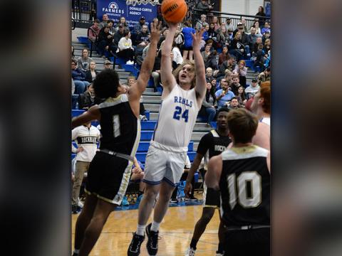 The Rebels’ Bryson Wright shoots a contested jump shot in basketball action.   