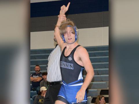 Senior Taylor Collis raises his hand in victory. 