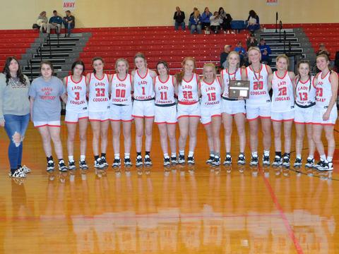 The Lady Cougars basketball team smiled together after being awarded the District Runner-Up plaque after the game Friday, February 17. Shown are, from left, Alyvia Harris, Lexy Jory, Brilee Harris, Sarah Collis, Cora Kimsey, Peyton Grabowski, Riley Akens, Peyton Williamson, Destiny Pittman, Alexis Hyatt, Sapporiah Ross, Riley Hall, Kendra Deal and Zoe Green.  