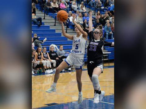 Lady Rebels Senior Reigan O’Neal  (#5) shoots for a contested two in recent Fannin basketball action. 