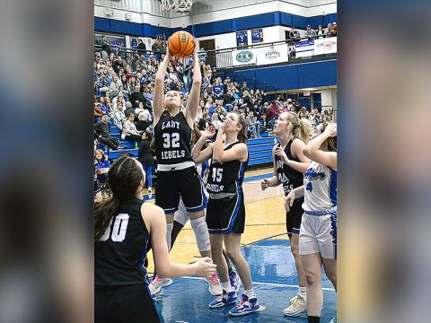 Fannin’s Macy Hawkins (32) snags a rebound with Reese Lewis (45) and Avi Ethington (30) ready to help in recent Lady Rebel action. 