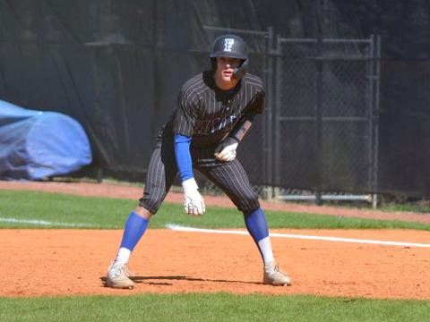 Senior Bryson Holloway gets ready to make a play as he watches the pitch from first base.