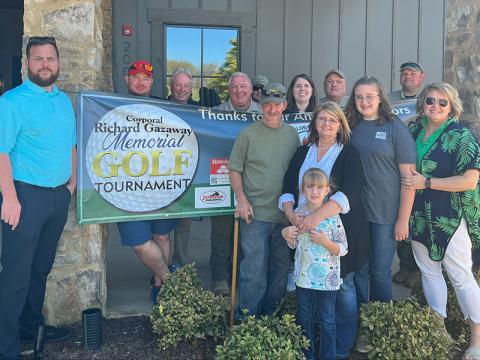 Richard and Heather Gazaway’s daughters, Skylar and Riley, and several other family members were among special guests at the Coporal Richard Gazaway Memorial Golf Tourney. They are shown in front of the banner with Wayne and Glenda Stover and Dawn Jamison. Among the many volunteers who worked to organize the tournament and make it a success are, from left, Dustin Carder, Jacob Pless, Todd Pack, Charles Yannis, Justin Turner, Amber Twiggs, J.K, Davenport, and Brad Mathis.