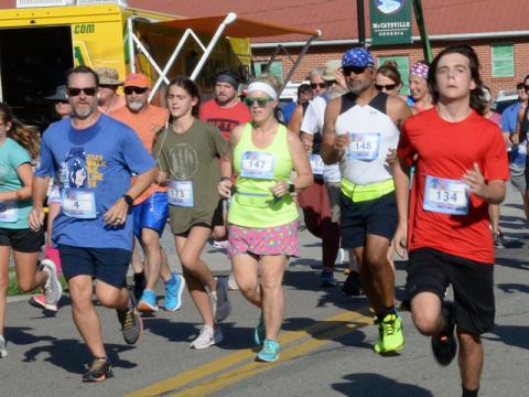 Runners take off from the start line in the Walk the Line 5K in McCaysvile. The race, part of the Riverwalk Run Series, takes competitors across the Toccoa River into Tennessee then back into Georgia in the two-state event. 