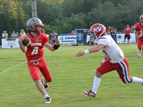 Copper Basin’s Cade Dean (4) is chased by a Polk County defender in the Cougars season opener Friday night.