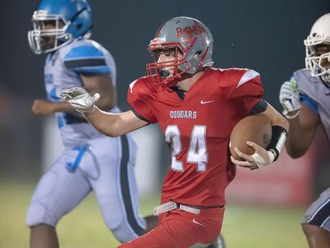 Copper Basin’s Harrison Brown looks to avoid tacklers in the Cougars win over New Faith Christian Academy.
