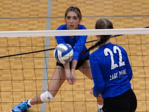 Peyton Slone sets up a return as Karis McIver (22) gets ready for a kill for the Fannin County Lady Rebels volleyball team.