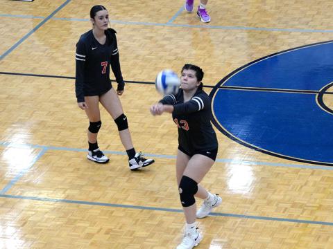 Nicole Marie (#13) sets up a return for the Lady Cougars as Sarah Collis (#7) waits.