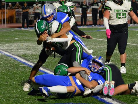 Scott Waldrep, on the ground, and C.J. Reece stop a Murray County runner in Friday night action at Fannin County High School. The Rebels posted a decisive 42-14 win in the Region 7-AA contest.