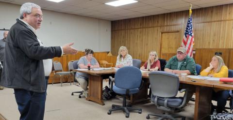 Tim Andrews, left, with the Tennessee Valley Railroad Museum, wants the Polk County Commission Board to create a railroad authority. Commissioners are skeptical, concerned about what might be hauled into Copperhill. Listening to Andrews’ proposal are, seated, starting second from left, commissioners Kelley Morgan, Samantha Trantham and Greg Brooks. 