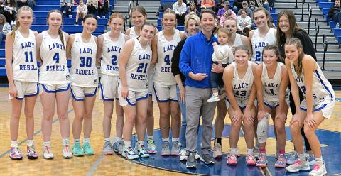 Fannin County Lady Rebels Head Coach Ryan Chastain was honored by the Fannin County Sports Hall of Fame for his 100th win in a brief ceremony Saturday. Shown helping Chastain celebrate are, from left, Jace Sanderson, Emma Buchanan, Avi Ethington, Albany Cole, Annabelle Anderson, Maggie Ledford, Emma Holloway, Amanda Chastain, Ryan Chastain, Ella Kate Chastain, Callie Ensley, Reese Lewis, and Addison Smith; and front, Izzie Jabaley, Courtney Davis, and Macy Hawkins. 