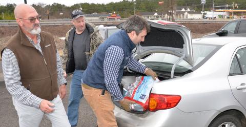 Ross Tarver and Kyle Cooper stayed busy loading water donated by Crystal Geyser Spring Water into residents’ vehicles last week. Tarver and Crystal Geyser worked together to provide free water after the Copperhill system went dry due to pipes burst by the frigid cold weather.
