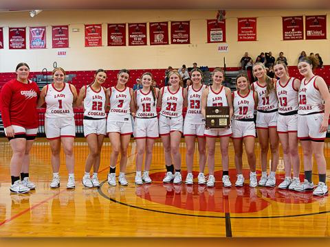 The Copper Basin Lady Cougars are shown with their District Championship trophy following their victory over Sale Creek. From left are Alyvia Harris, Claire Ledford, Addison Hyatt, Sarah Collis, Riley Akens, Cora Kimsey, Zoe Green, Riley Hall, Kendra Deal, Alexis Hyatt, Peyton Grabowski, and Kloie Ballew.