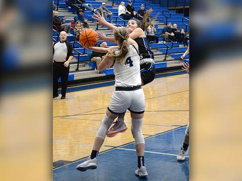 Courtney Davis goes up and around a defender as she drives the lane for the Lady Rebels.