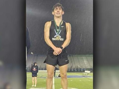 Zechariah Prater is shown on the podium after finishing first in the 1600 meter run.