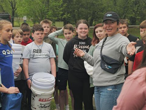 Students listen as Christy Gribble, President and CEO of the Fannin County Chamber explains Arbor Day. 