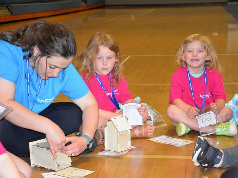 Morgan Thomas, left, gives Lyla Swafford a hand in putting the final touches on her birdhouse.