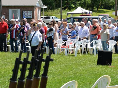 Veteran Kevin O’Quinn leads members of the Memorial Day crowd in saluting during the service Monday, May 27, at Veterans Memorial Park in Blue Ridge.