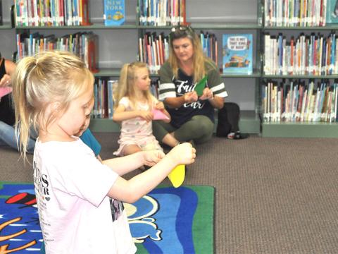 Charlotte Bailey and her little sister, Adeline Bailey learned how to make a firefly out of a piece of paper.