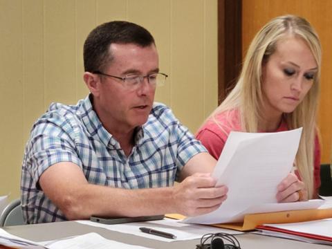 Polk County District 3 Commissioner Keith Barker reads a resolution presented by District 3 Commissioner Samantha Trantham, right, that would have expressed the commission’s disapproval for a Boys & Girls Club to be located on the Copperhill Industries Superfund sSite.