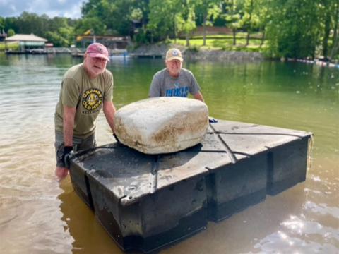 Former LBRCA President Dale Greene and current LBRCA President Dan Myers pose with an abandoned dock float which could pose a hazard to boaters.