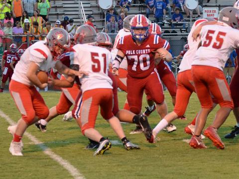 Copper Basin’s Luke Elrod takes a handoff as Seth Picklesimer sets a block in the Cougars game against Polk County.