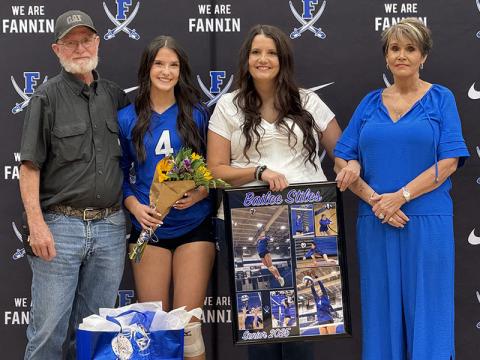 Bailee Stiles was escorted by Megan Stiles, Edward Stiles and Becky Harbin during Volleyball Senior Night ceremonies.