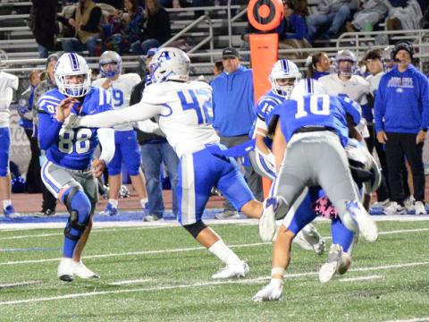 Luke Holsonback (10) catches the Armuchee quarterback from behind as Scott Waldrep (15) cuts off his running room and Noah Burnettmakes his way around an Indian blocker Friday night on the Fannin County football field.