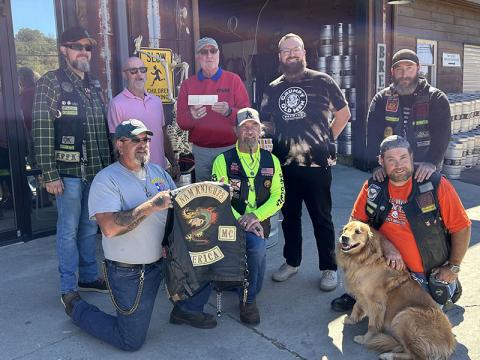 Dale Greene, co-coordinator of Toys for Tots of Fannin County, along with Jeff Young, owner of Grumpy Old Men Brewing, accepted a $1,900 from Nam Knights Motorcycle Club members. The club raised the money on a ride through Fannin County. Grumpy Old Men is a regular supporter of Toys for tots, and will host its annual fundraiser November 29.