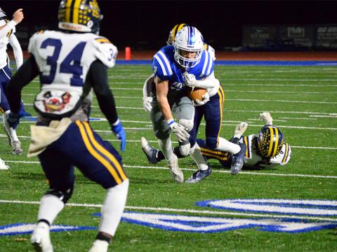 Fannin County’s Braden Taylor works to escape the grasp of a Jeff Davis defender Friday night. 