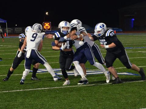 Braden Taylor (4) fights for yardage against Gordon Lee with the help of Baylor Twiggs (55).