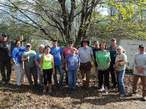 Freedom for Fido recently completed its 150th fence build Friday, November 8, in Epworth. Volunteers are shown, from left, Nick Robinson, Pepperr McConnell, Dee Hoult, Sheila Robinson, Carol Shannon, Jimmy Jones, Eric Pavis, Co-Founder Jackie Gilbert, Co-Founder Fritz Gilbert, Andy Livingston, Peggy Caldwell, Robert Simpson, Sandra Simpson and Tom Corey.