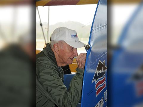 World War II Navy veteran Bill Langford signs the rudder of the plane following his “Dream Flight.” This is a privilege for WWII veterans alone.