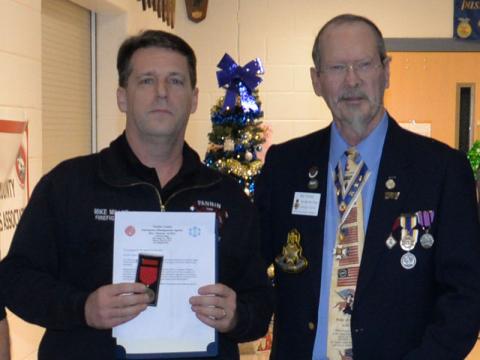 Firefighter Mike Miller received a special award from Sid Turner of the Sons of the American Revolution.